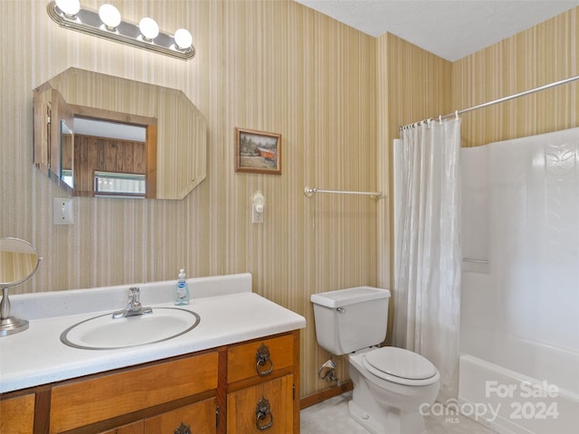 full bathroom with toilet, shower / tub combo with curtain, a textured ceiling, and vanity