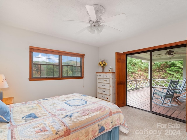 bedroom with ceiling fan, carpet, access to outside, and a textured ceiling