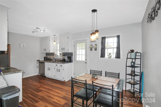 dining space featuring dark wood finished floors and baseboards