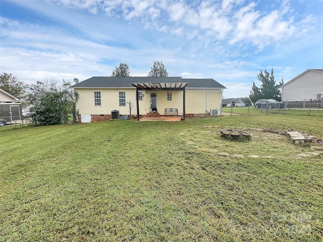 rear view of house with fence, a pergola, a yard, central air condition unit, and a patio