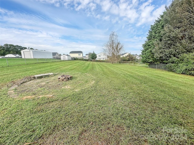 view of yard with an outdoor fire pit