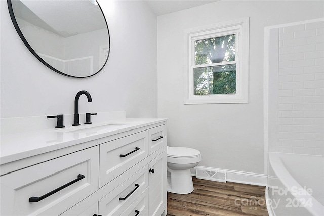 bathroom featuring hardwood / wood-style flooring, vanity, and toilet