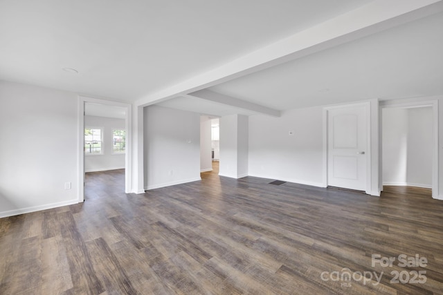 unfurnished room with beam ceiling and dark hardwood / wood-style flooring