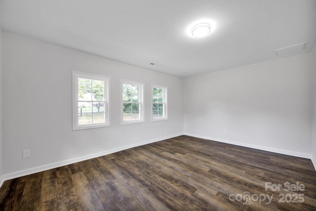 spare room with dark wood-type flooring