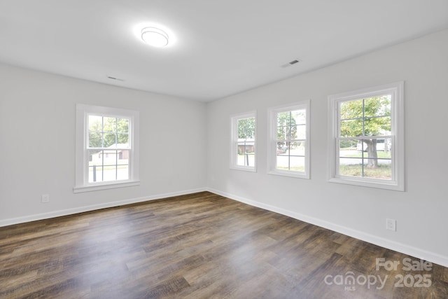 unfurnished room featuring dark wood-type flooring