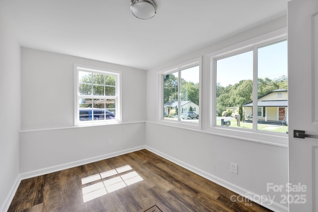 spare room with dark hardwood / wood-style floors