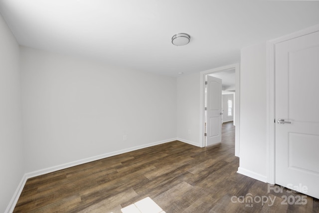 spare room featuring dark wood-type flooring