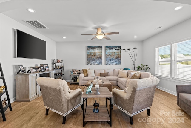 living room with ceiling fan and light hardwood / wood-style flooring