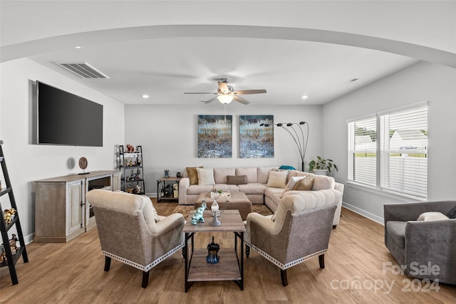 living room featuring light hardwood / wood-style floors and ceiling fan