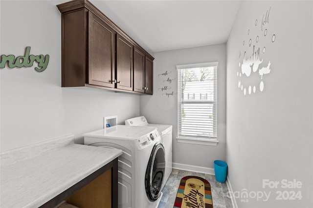 laundry room with washer and dryer and cabinets