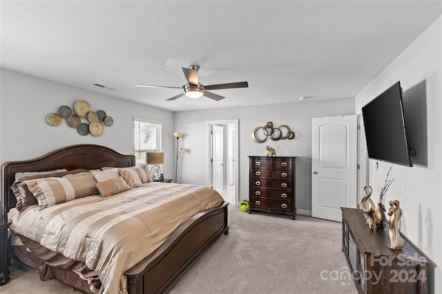 bedroom with ceiling fan and light colored carpet