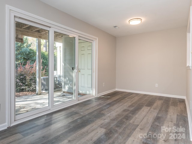 spare room with dark hardwood / wood-style floors