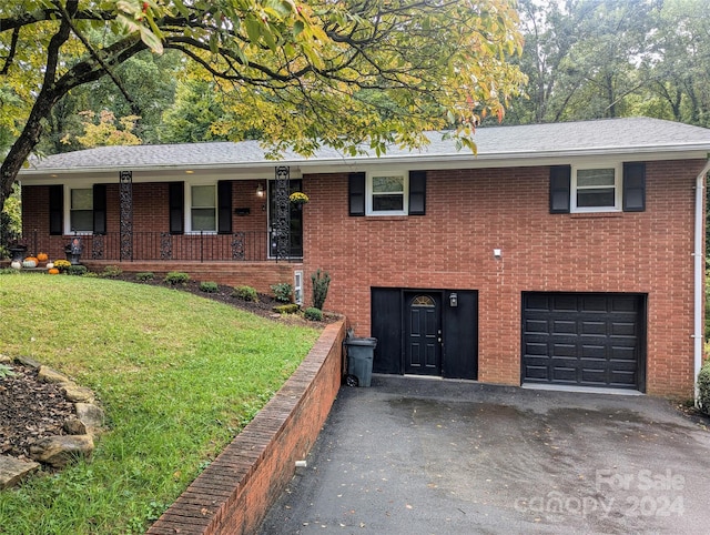 ranch-style house with a garage and a front lawn