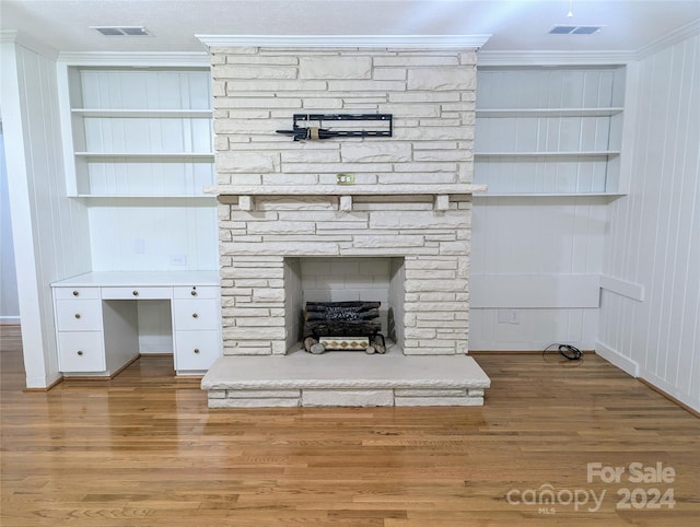 details with crown molding, a fireplace, and hardwood / wood-style flooring