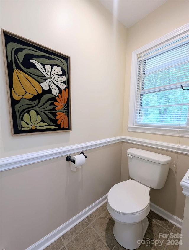 bathroom with toilet and tile patterned flooring