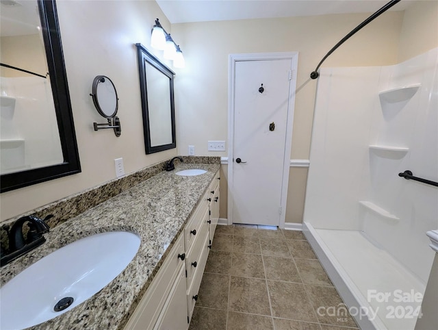 bathroom featuring vanity and a shower