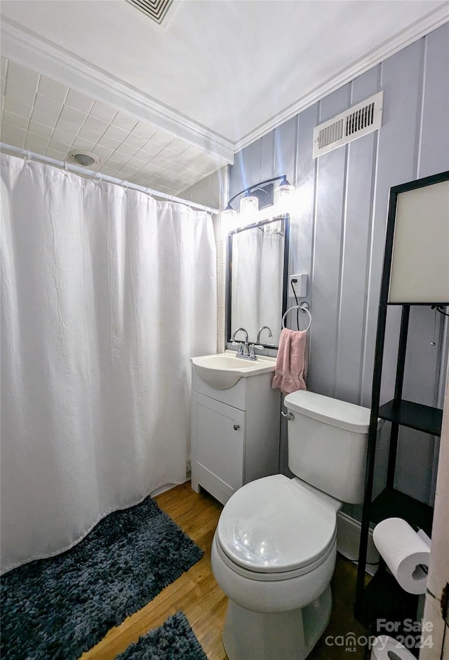 bathroom featuring vanity, toilet, hardwood / wood-style flooring, and a shower with curtain