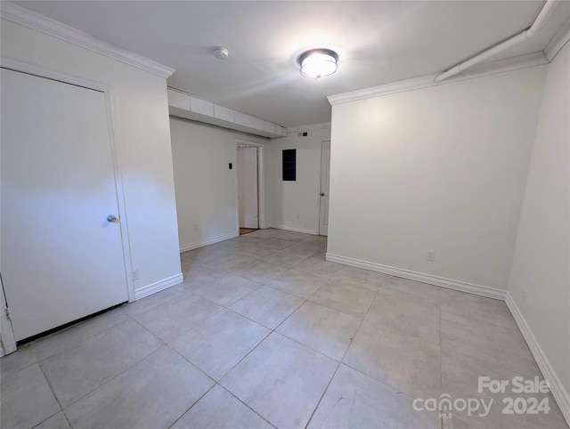 empty room featuring ornamental molding and light tile patterned flooring