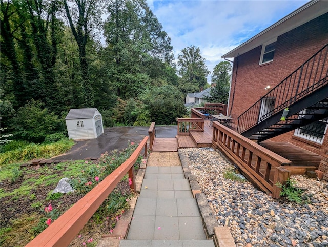 view of yard featuring a storage unit and a deck