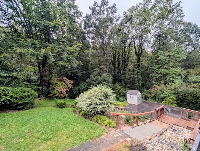 view of yard featuring a storage unit and a deck