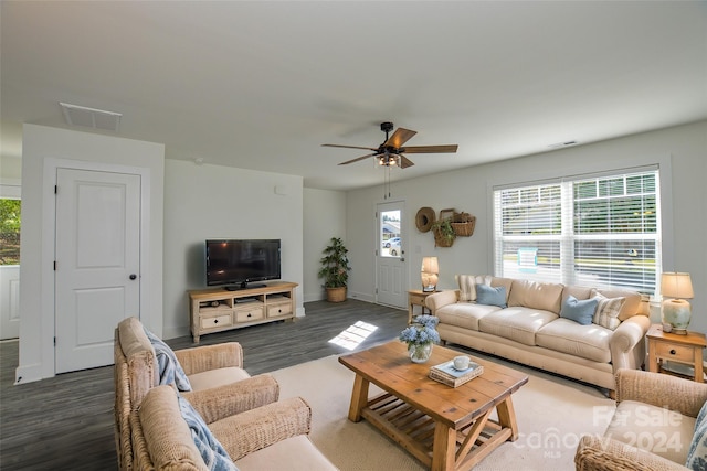 living room featuring ceiling fan and dark hardwood / wood-style floors