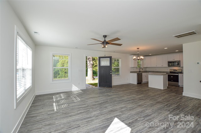 unfurnished living room with sink and ceiling fan with notable chandelier