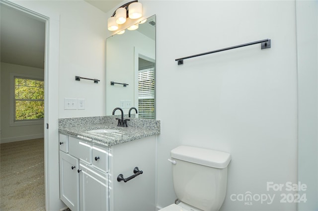 bathroom featuring toilet and vanity