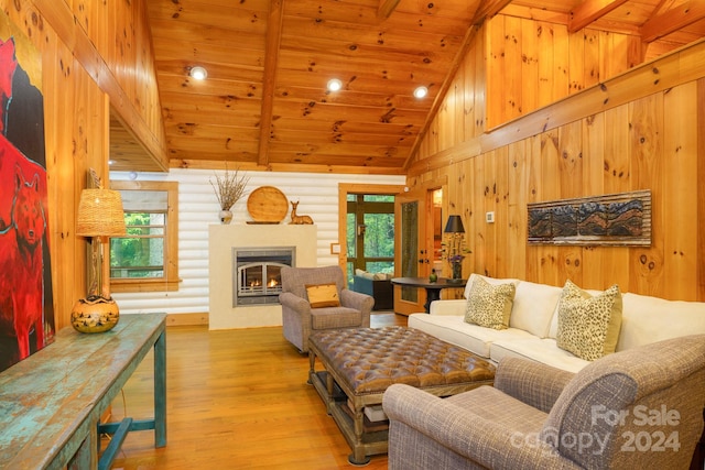 living room featuring high vaulted ceiling, beam ceiling, light hardwood / wood-style floors, and wooden ceiling