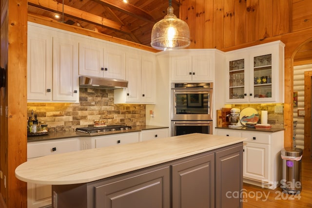 kitchen with appliances with stainless steel finishes, hanging light fixtures, white cabinets, ventilation hood, and wooden ceiling