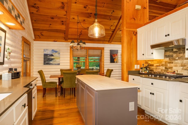 kitchen featuring wood ceiling, white cabinetry, stainless steel appliances, a center island, and decorative light fixtures