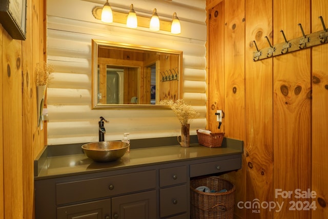 bathroom with vanity and rustic walls