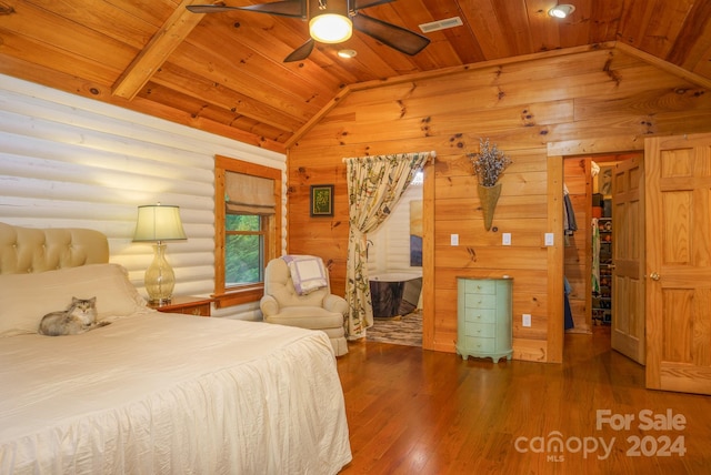 bedroom with ceiling fan, lofted ceiling, rustic walls, wooden ceiling, and dark hardwood / wood-style flooring