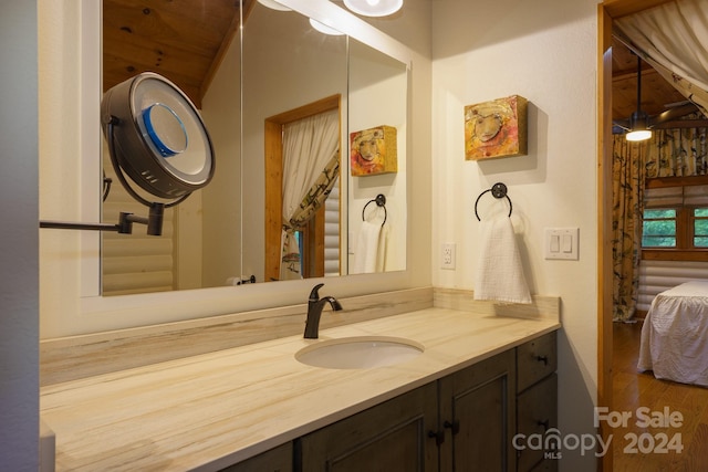 bathroom with wood-type flooring, vanity, and wooden ceiling