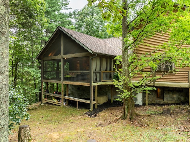 back of property with a sunroom