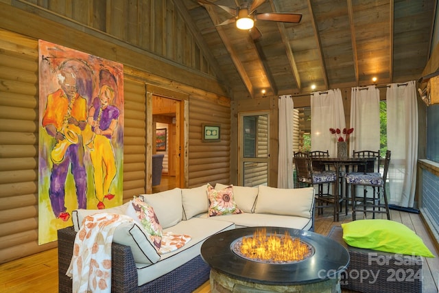 exterior space featuring ceiling fan, vaulted ceiling with beams, and wooden ceiling