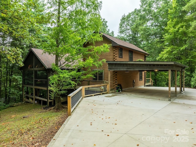 17200 Rosman Hwy, Lake Toxaway, NC 28747 - view of front of property with log exterior, concrete driveway, and a carport