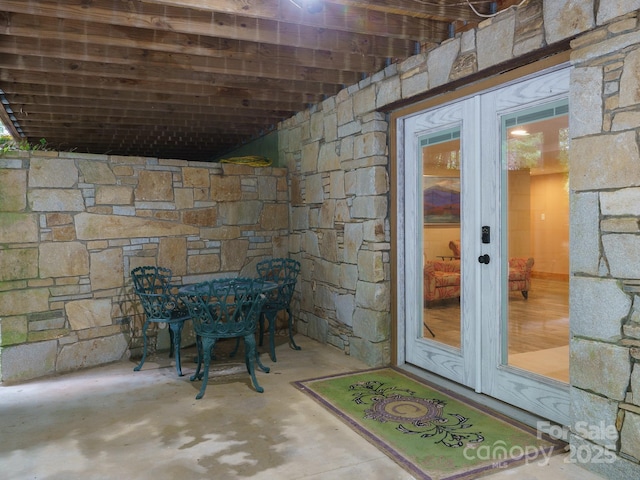 17200 Rosman Hwy, Lake Toxaway, NC 28747 - view of exterior entry with french doors, stone siding, a patio, and outdoor dining area