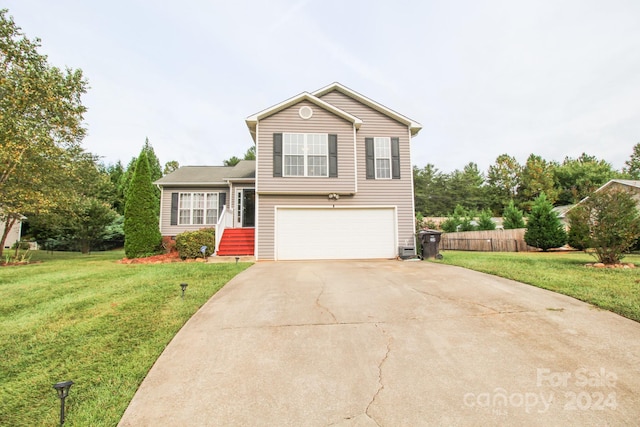 split level home with a front yard and a garage