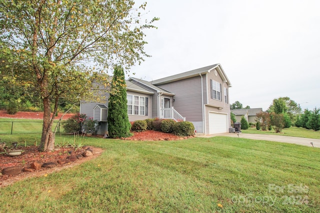 view of front of house featuring a front yard and a garage