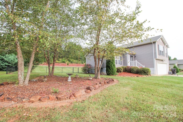 view of front of property with a garage and a front yard