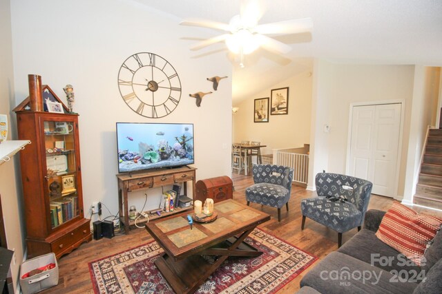 living room featuring ceiling fan, lofted ceiling, and wood-type flooring