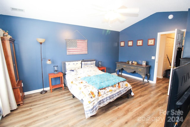 bedroom with wood-type flooring, lofted ceiling, and ceiling fan