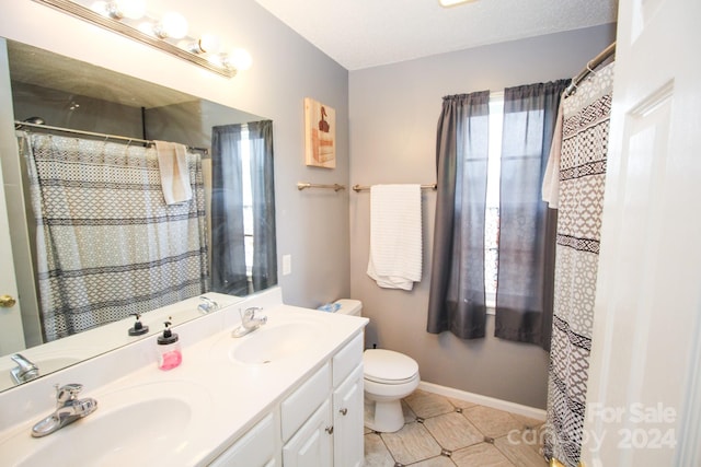 bathroom with curtained shower, tile patterned flooring, vanity, and toilet