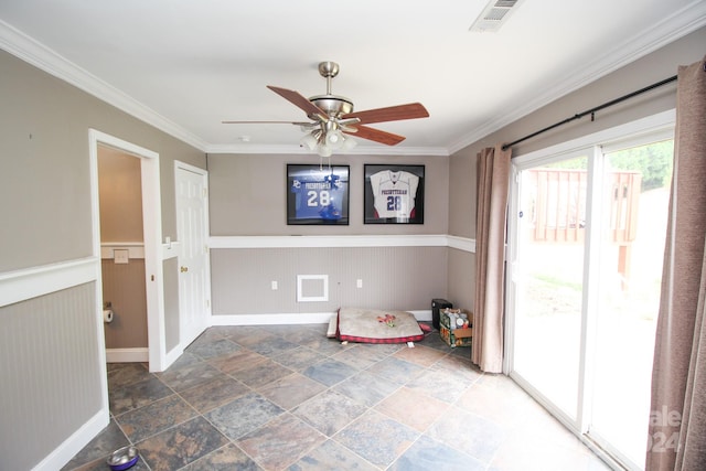 recreation room featuring wood walls, ceiling fan, and crown molding