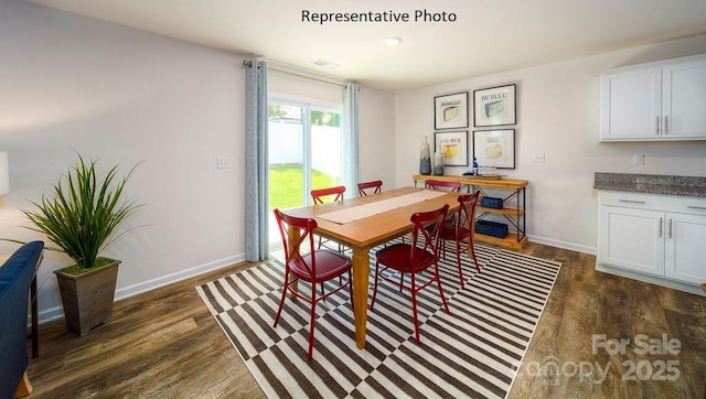 dining space featuring dark hardwood / wood-style flooring