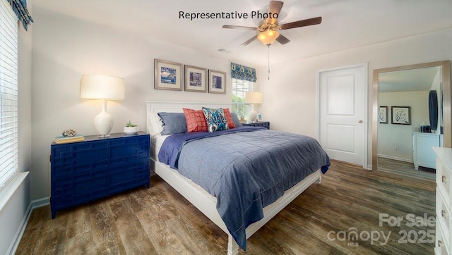 bedroom with ceiling fan and dark hardwood / wood-style floors