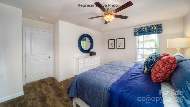 bedroom with ceiling fan and dark hardwood / wood-style floors