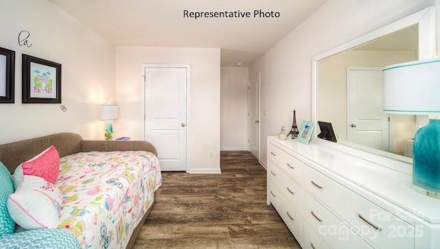 bedroom with a closet and dark hardwood / wood-style flooring