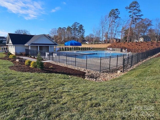 view of pool featuring a yard