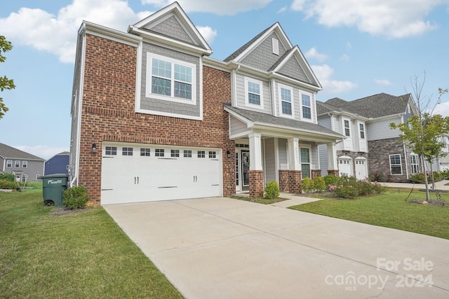 view of front of house with a front lawn, a porch, and a garage